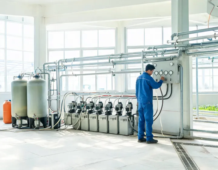 Fertilizer injection skid beside greenhouse irrigation headers